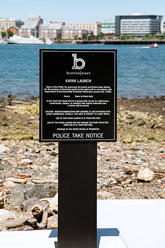 kayak launch sign in front of riverbed