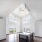 Modern kitchen looking into living area with vaulted ceiling and large windows