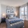 Large, floor-to-ceiling windows in a spacious bedroom with a bed