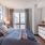 Modern bedroom with large windows overlooking Boston, MA
