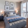 large, floor-to-ceiling windows brighten bedroom