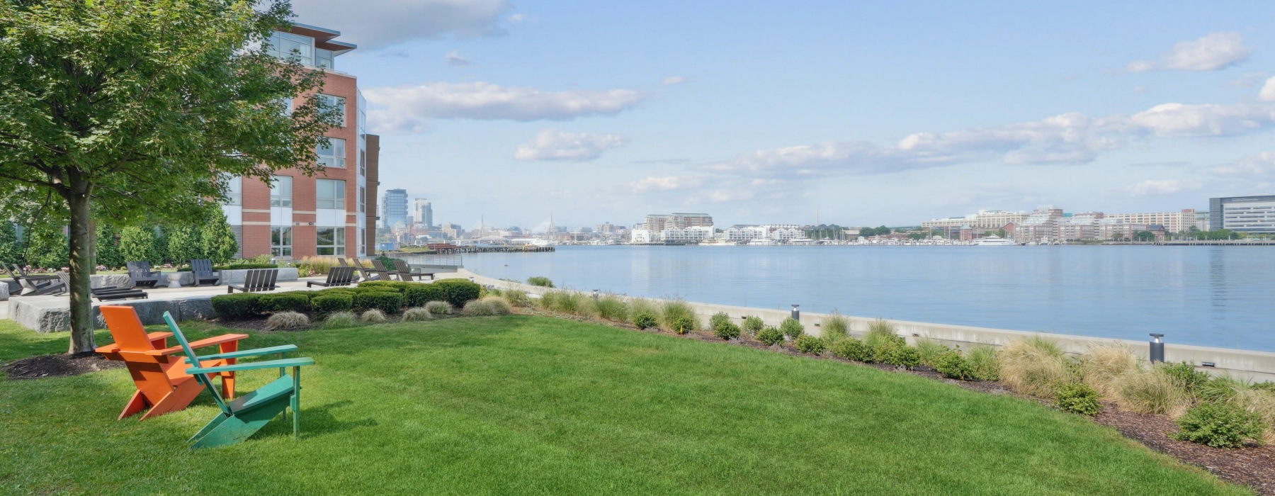 lawn chairs at Boston East with views of the harbor
